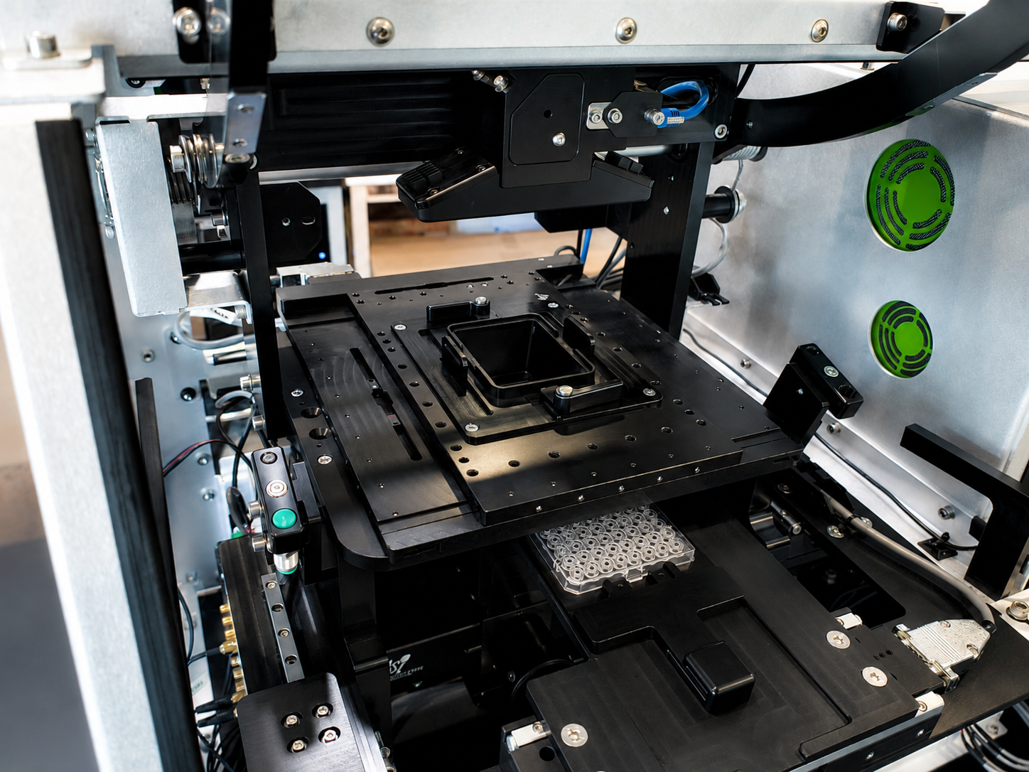 Image of an internal view of an imaging-based instrument showing integrated motion, imaging, and mechanical subsystems.